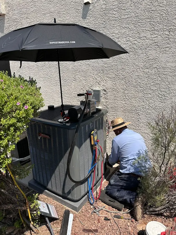 HVAC technician performing outdoor AC maintenance in Batesburg-Leesville