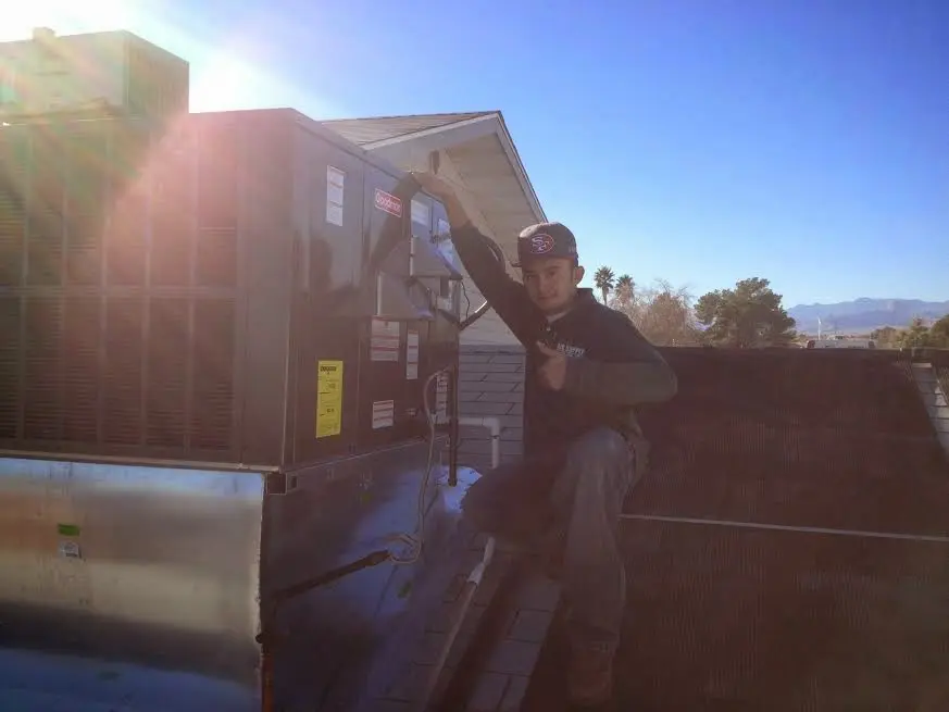 HVAC technician performing Heat Pump Repair on a rooftop unit in Batesburg-Leesville